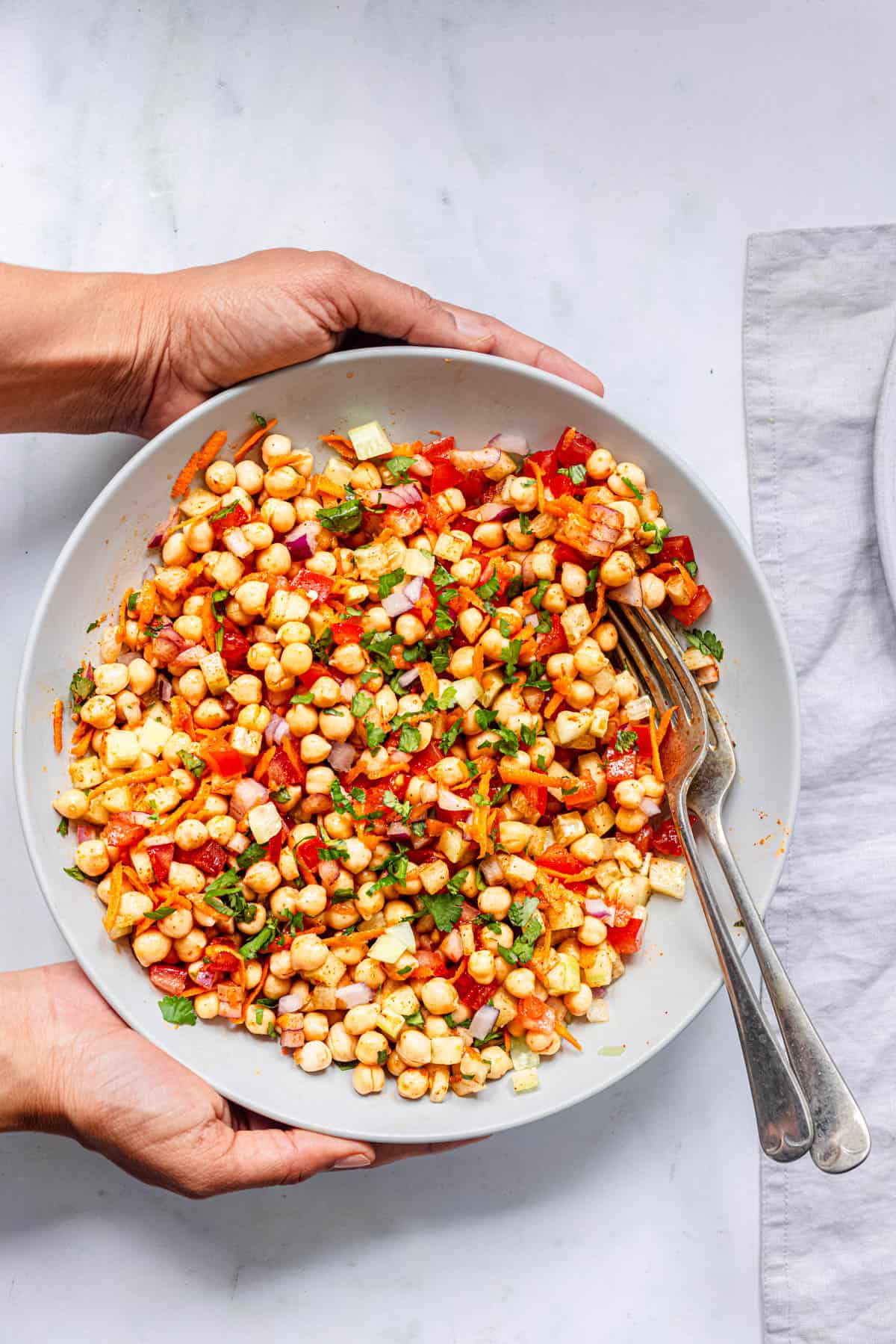 Indian chickpea salad in a white bowl.