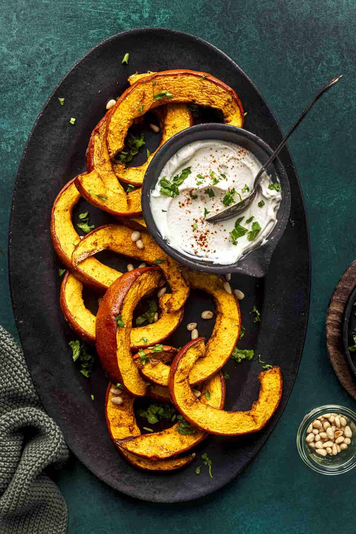 roasted air fryer pumpkin slices on a oval tray.