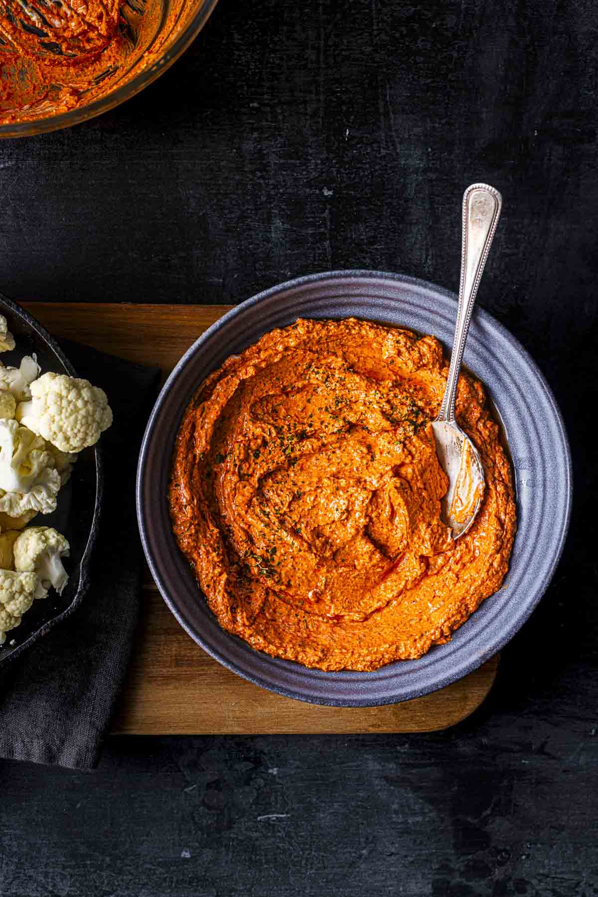 tandoori sauce marinade in a bowl and cauliflower