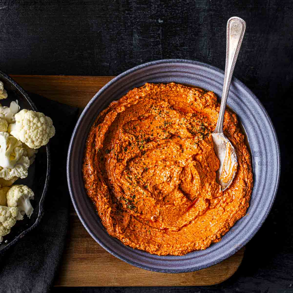 tandoori sauce marinade in a bowl and cauliflower