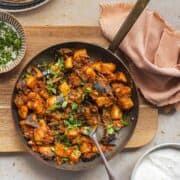 potato and aubergine curry in a skillet garnished with coriander.