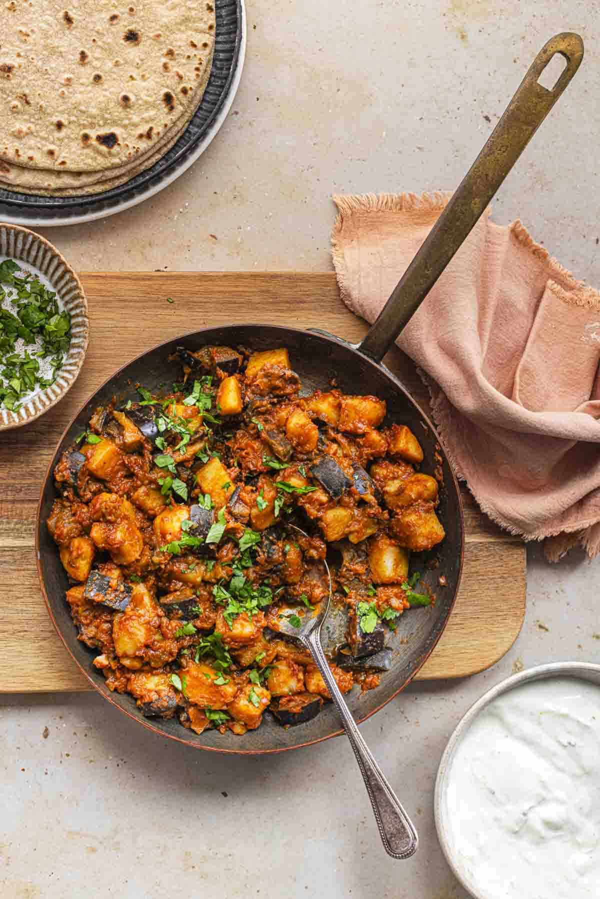 Indian potatoes and aubergine curry served with chapathis and yogurt.