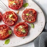 air fryer roasted tomatoes in a oval serving plate.