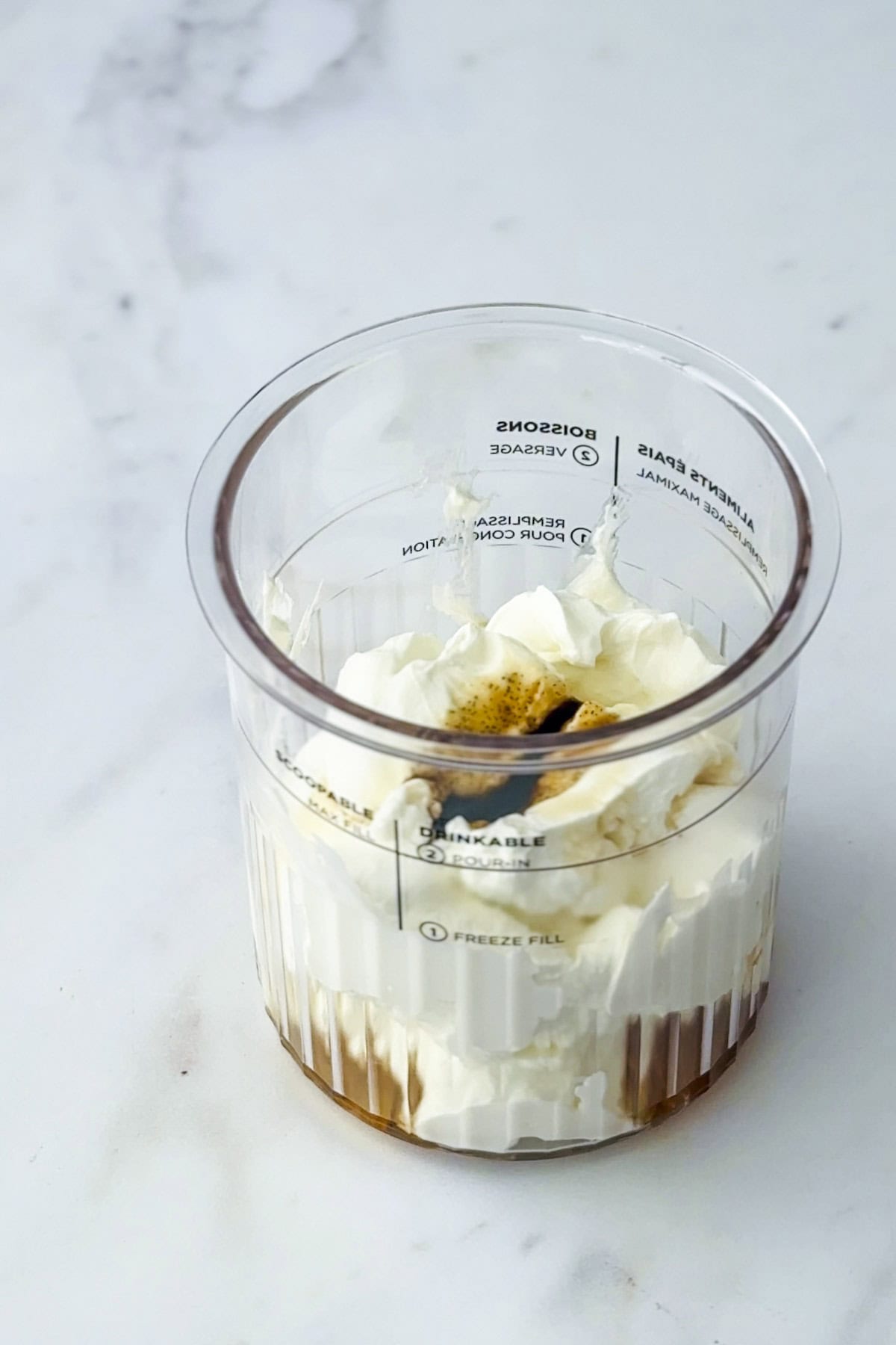 greek yogurt, maple syrup and vanilla bean paste in a ninja creami pint tub.