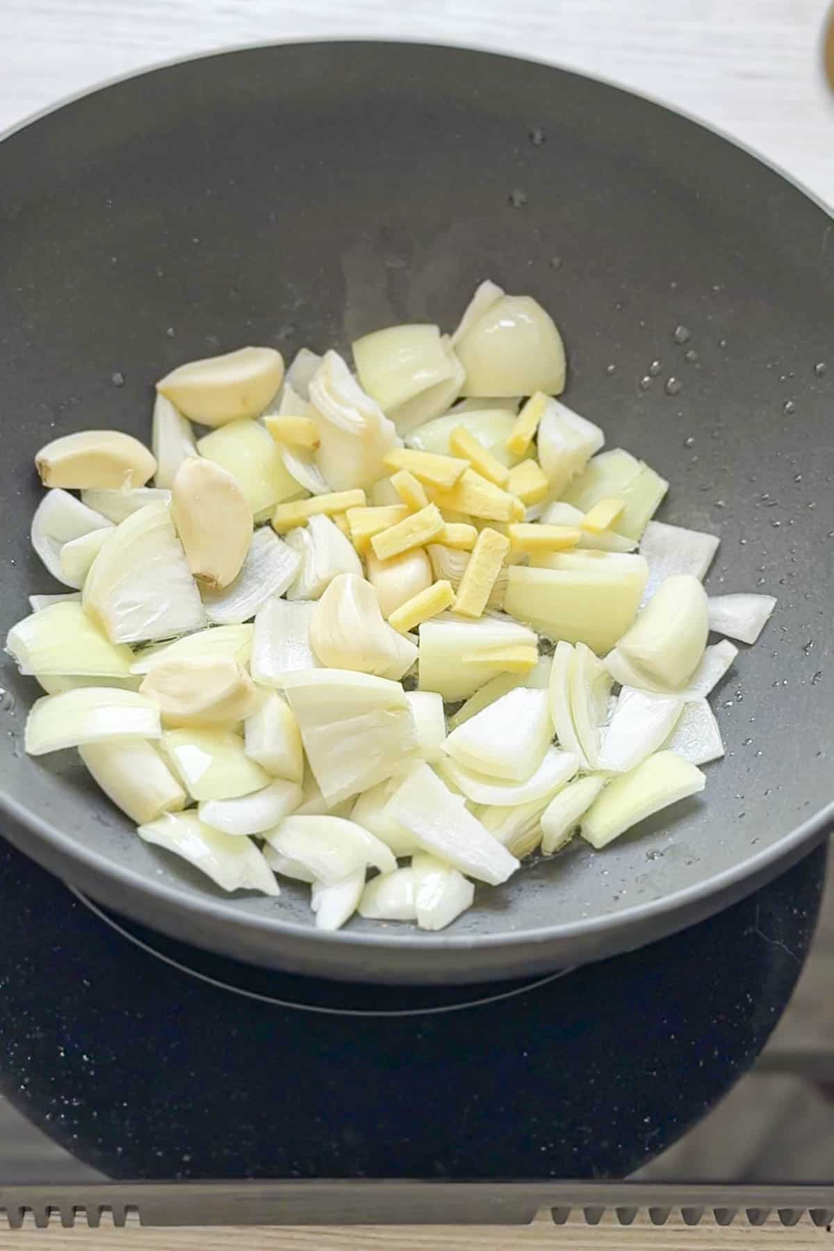 ginger garlic and onion in a wok.