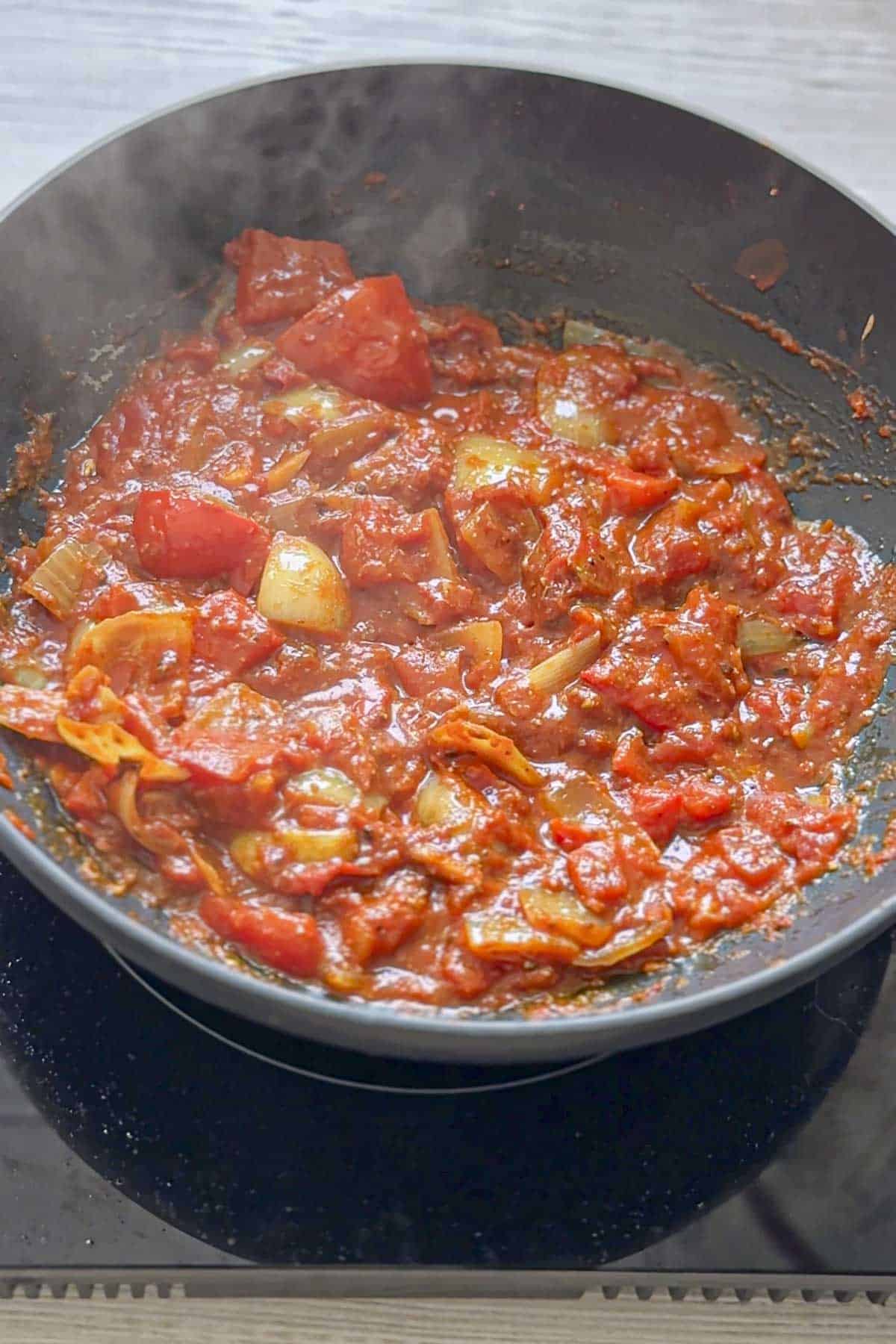 cooking the balti sauce in wok.
