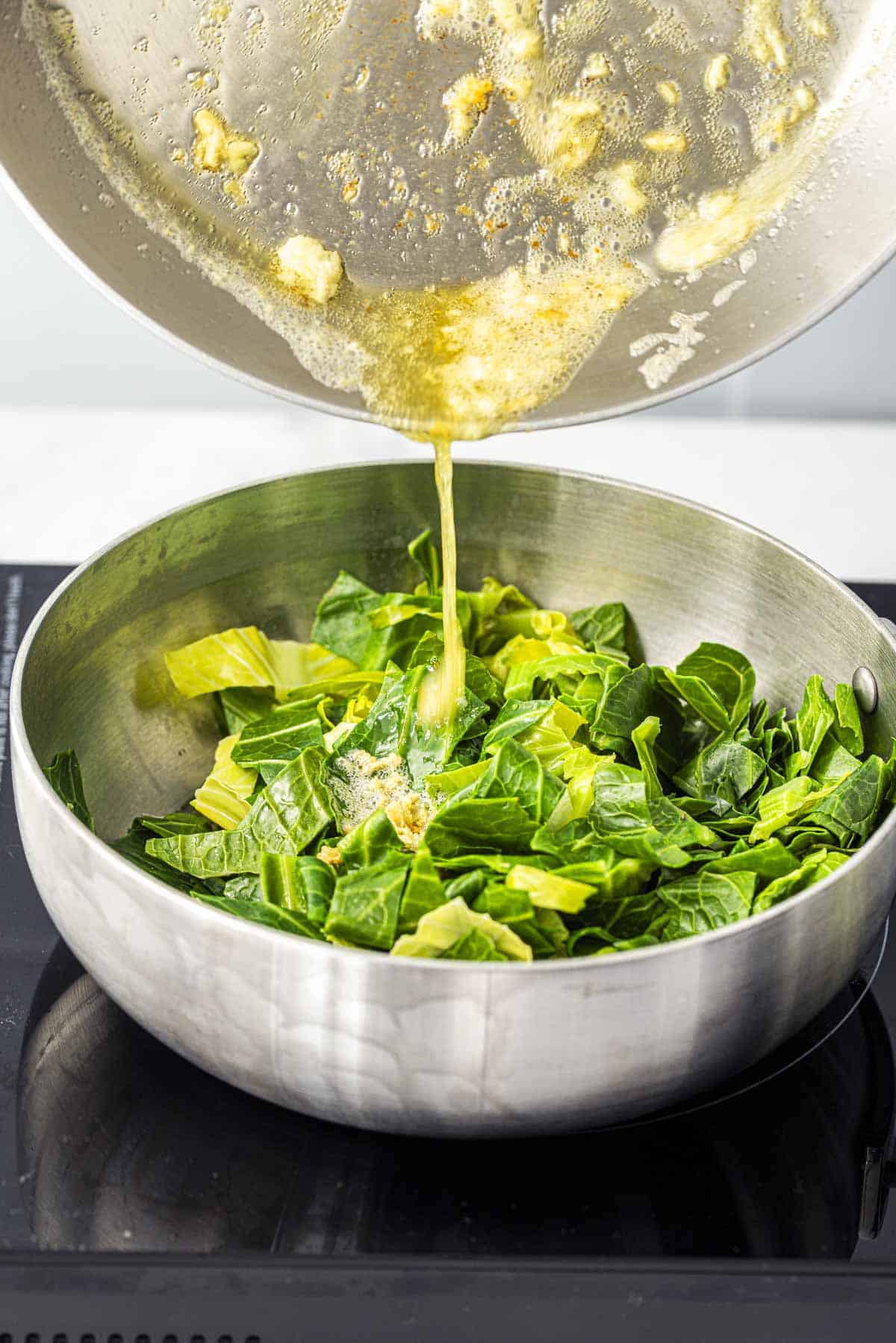 Add melted garlic butter to the spring greens.