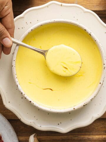 saffron cream pasta sauce in a white bowl.