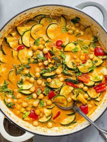 creamy courgette and chickpea curry in a pan.