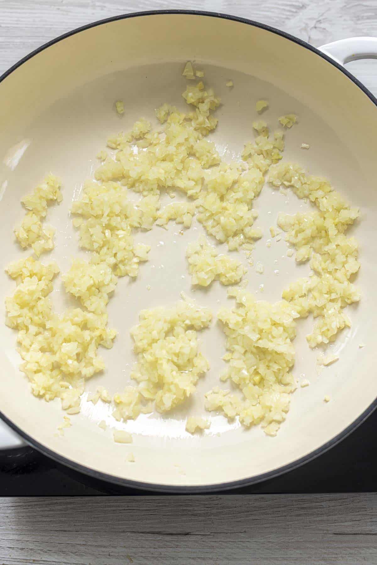 Onion, Ginger Garlic in a white pan.