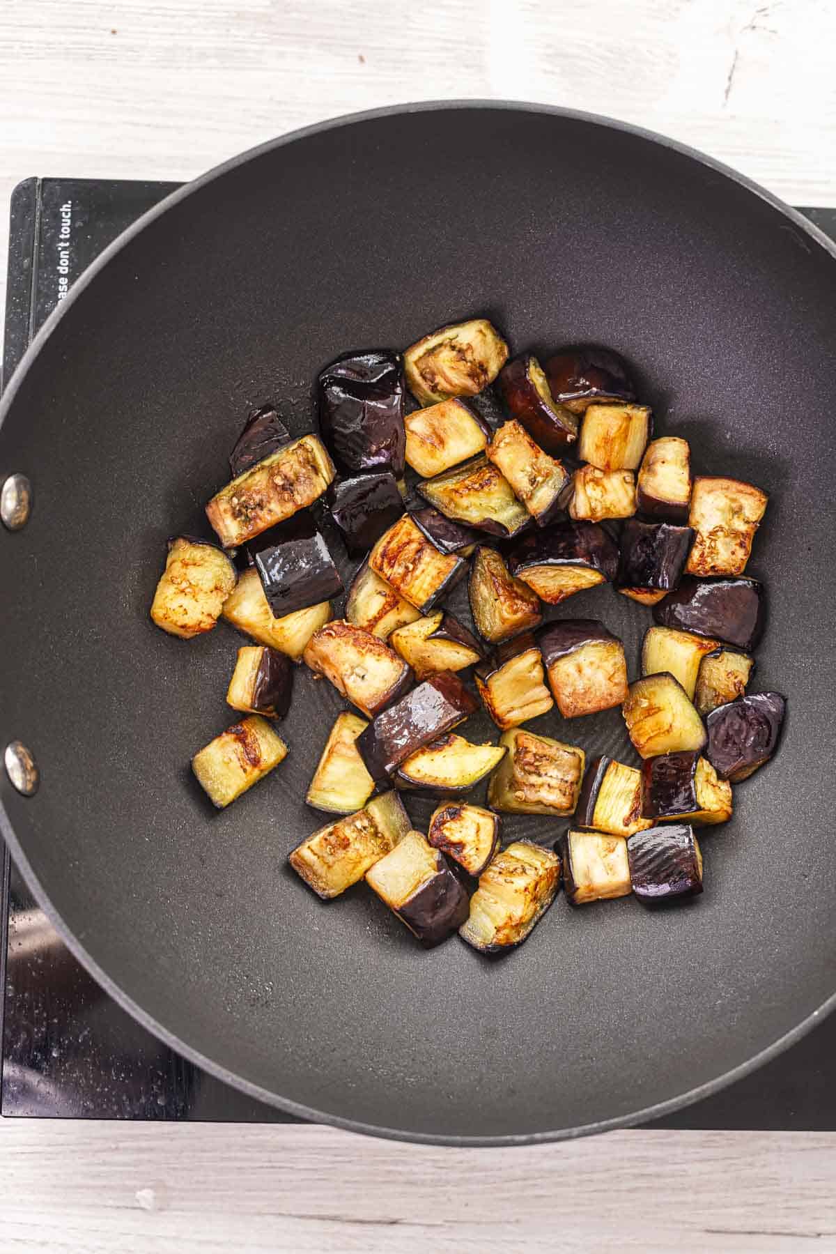 roasted aubergine in a wok.