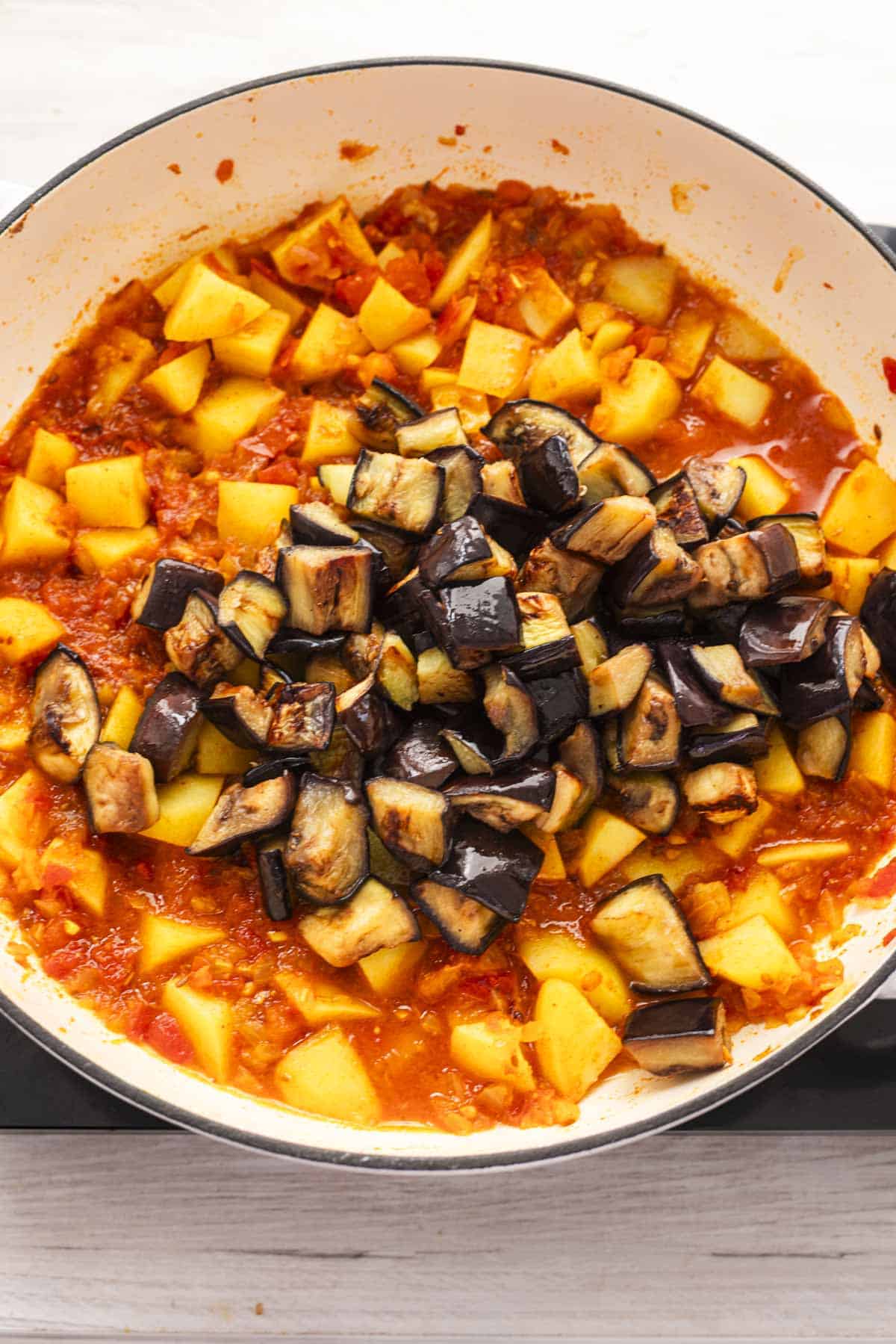 aubergine over potato tomato onion gravy.