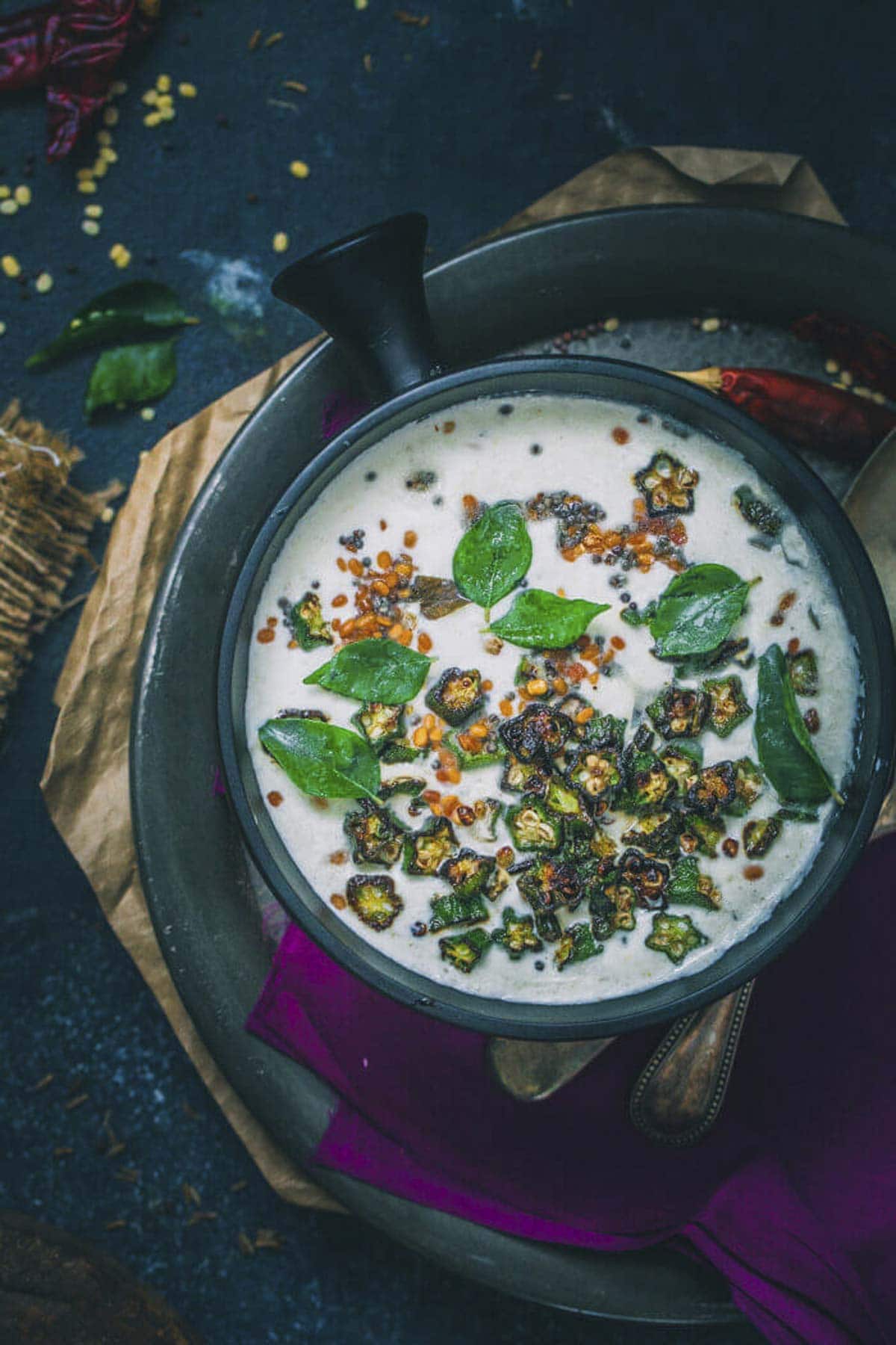 okra pachadi served with fried okra and tempering in a bowl.