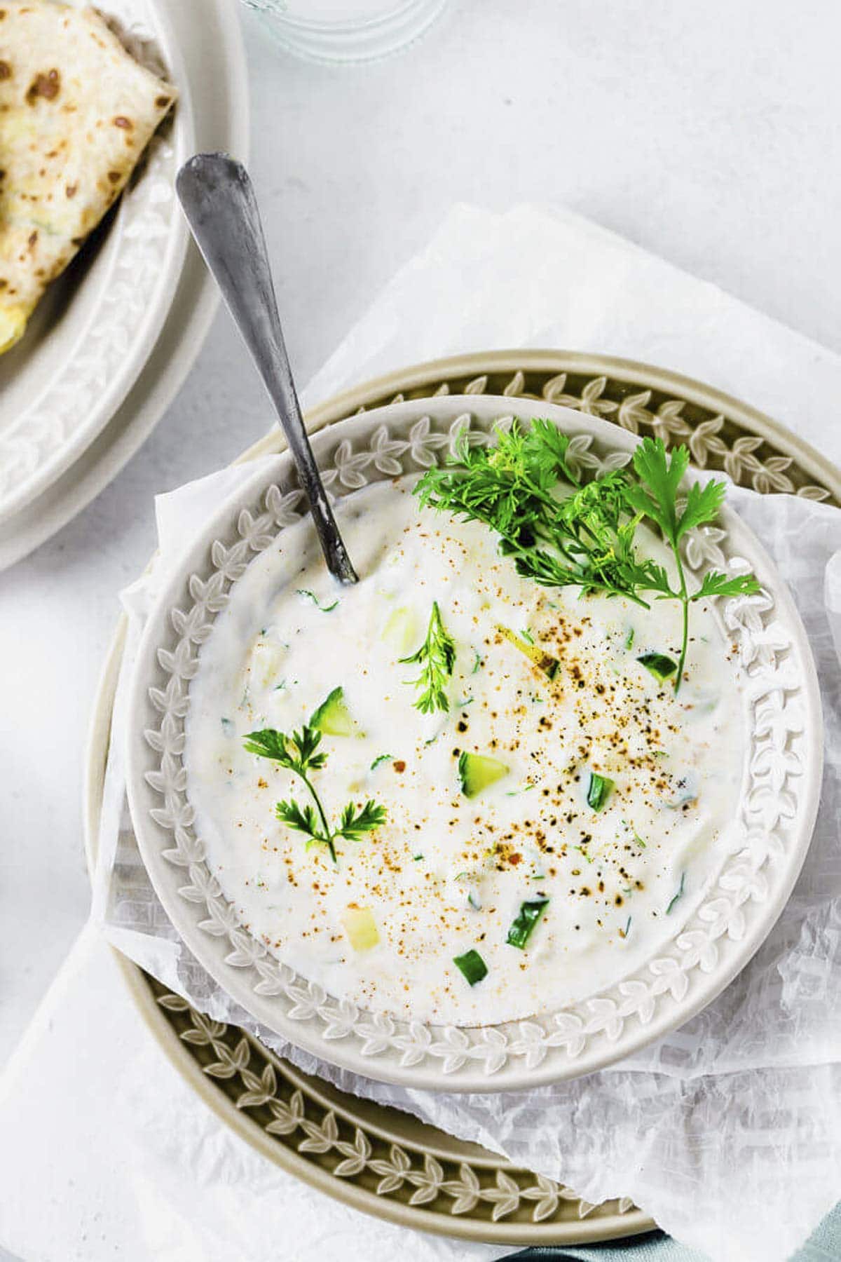 cucumber raita served in a bowl.
