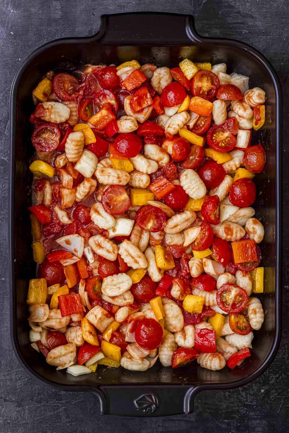 add all the ingredients for traybake in the black roasting dish.