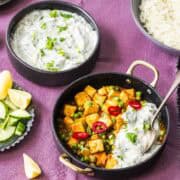 tofu korma served with vegan raita in a bowl.