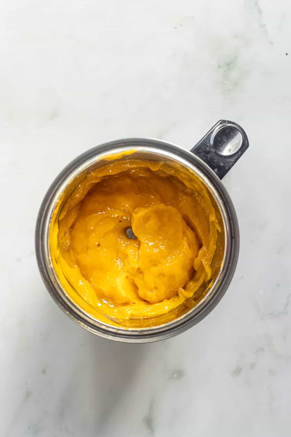 blended creamy mango puree in a blender jar.