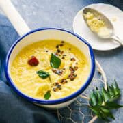 Mambazha Pulissery served in a white sauce pan.