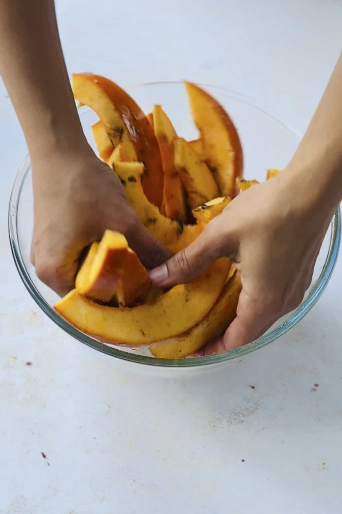 marinating the pumpkin with spices and oil.