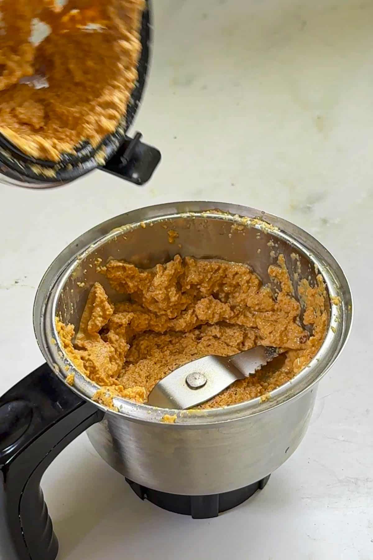 ground coconut paste in a blender jar.