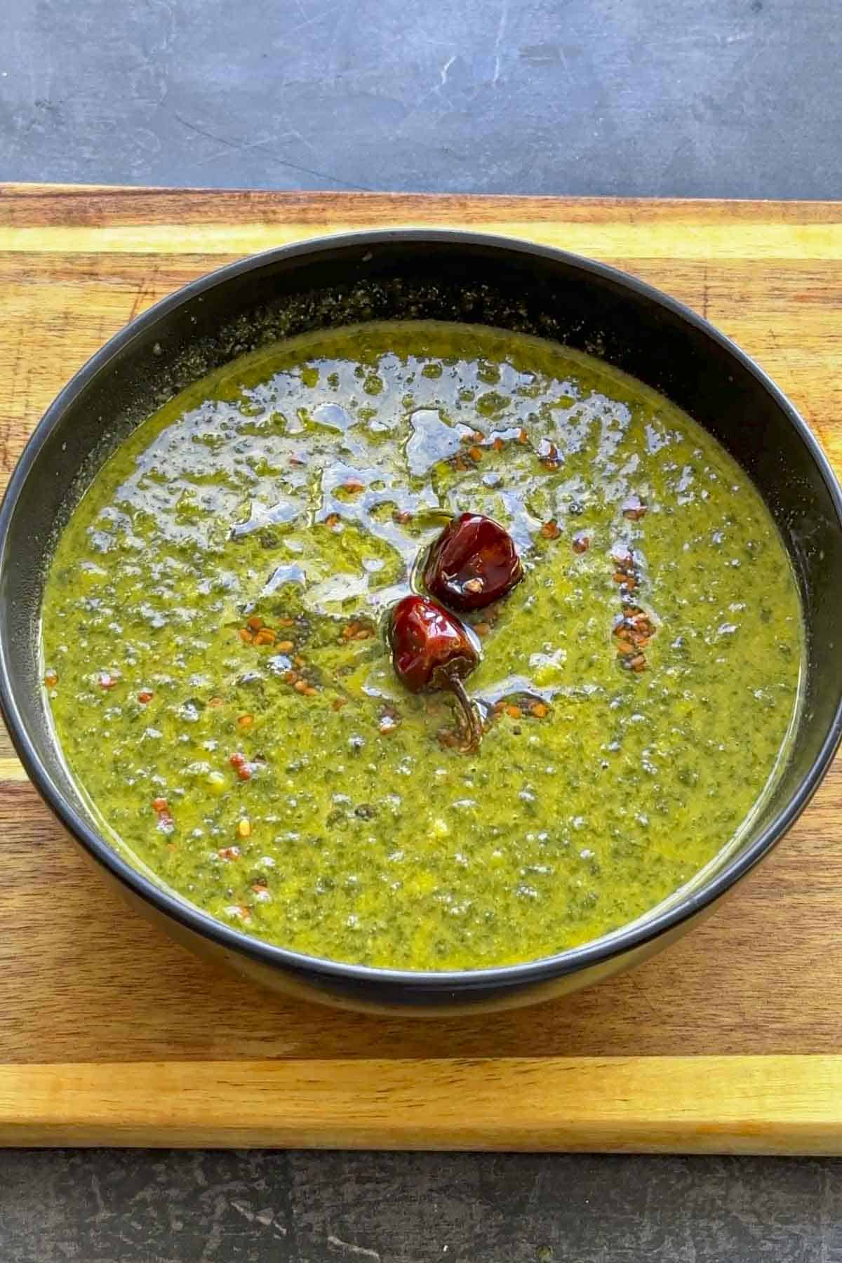 keerai molagootal in a black bowl.