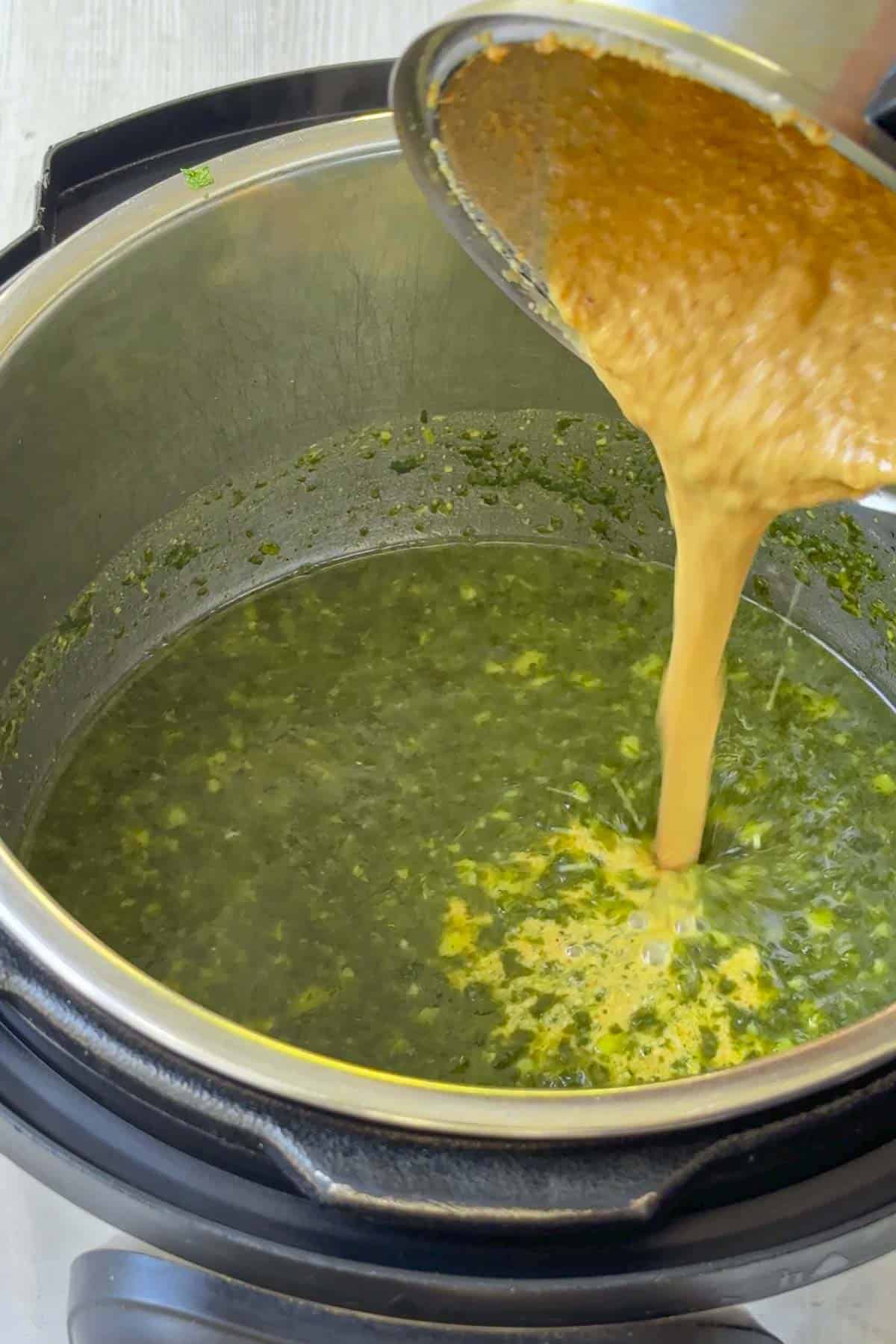 combine the spinach molagootal with coconut paste.