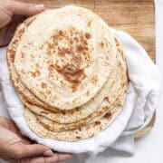 stack of 6 cottage cheese flatbreads on a white cloth.