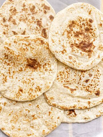 6 cottage cheese flatbreads made without egg on a serving board.