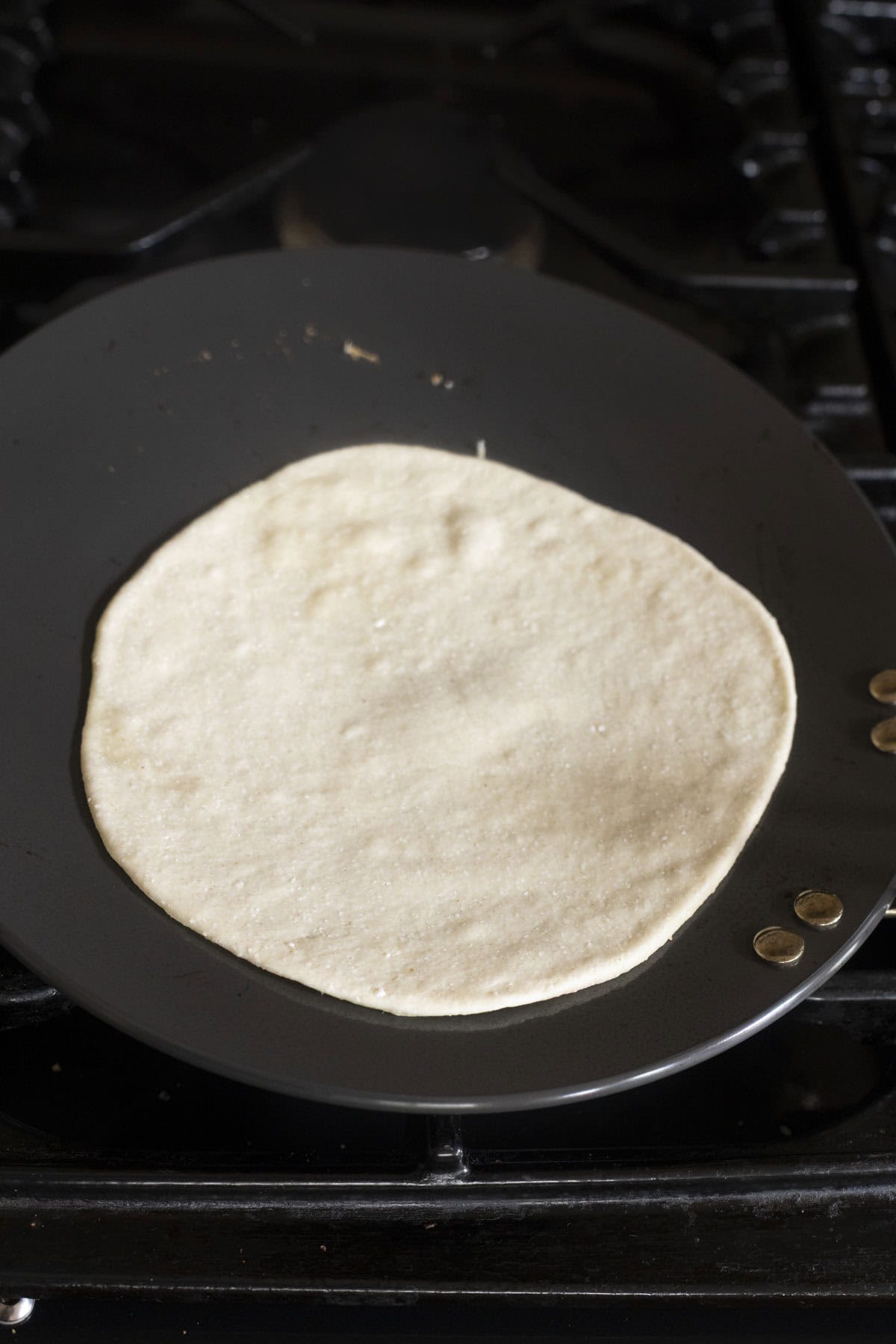 rolled cottage cheese flatbread on a skillet.