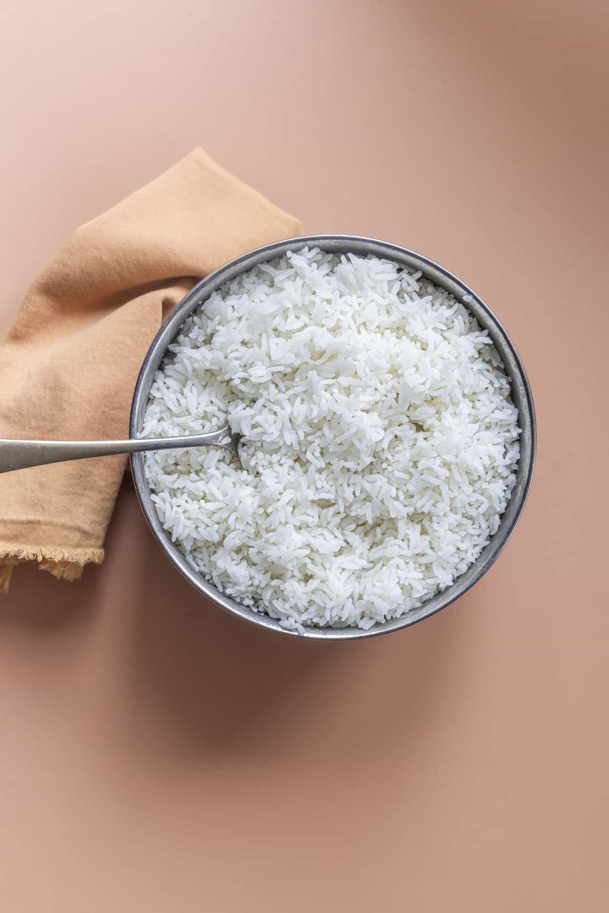 fluffy sona masoori white rice in a steel pot.