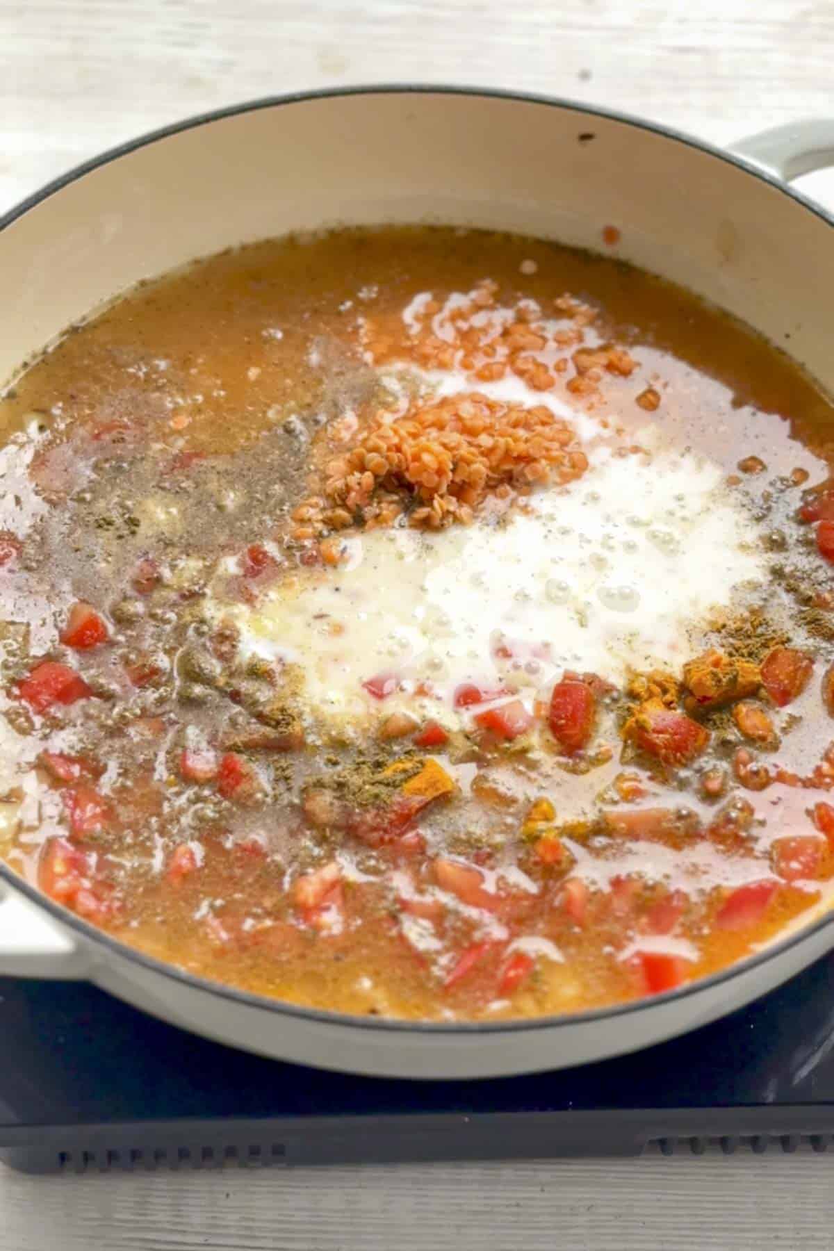 red lentils, broth, coconut milk and spices in the pan.