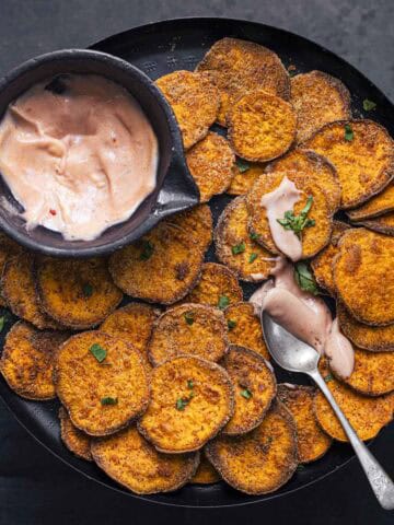 air fried sweet potato slices served with sauce.