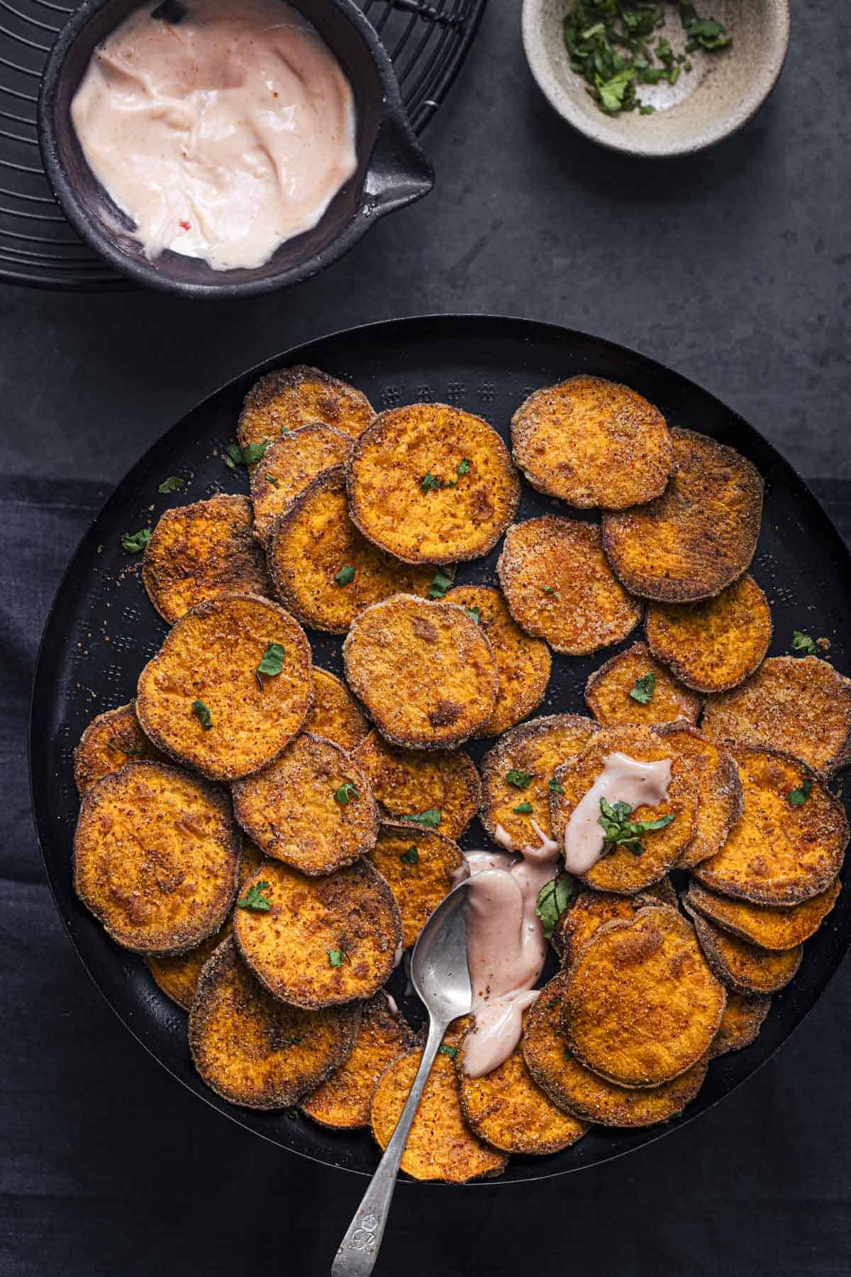 air fried sweet potato slices served with sauce.