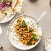 one pot vegan chickpea spinach curry with coconut milk served over rice.