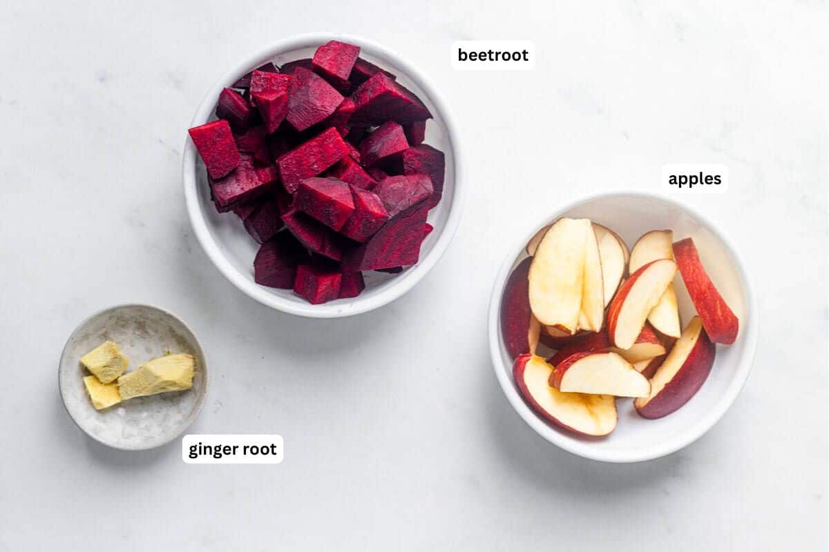 ingredients to make fresh beet apple ginger juice in slow juicer and blender.