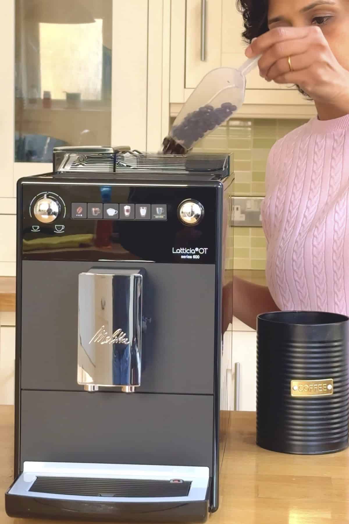 adding coffee beans to the bean to cup melitta coffee machine.