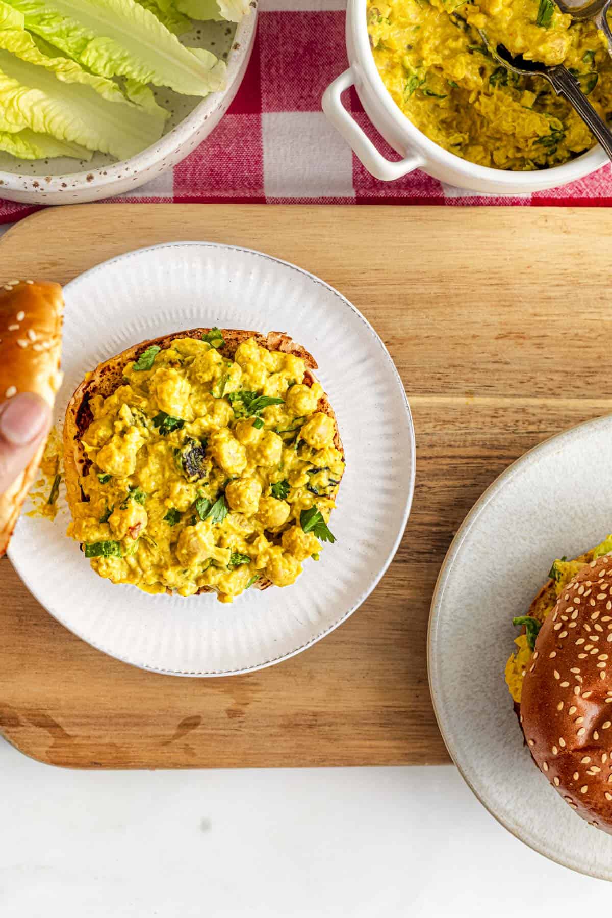 coronation chickpeas sandwich filling on top of burger bun.