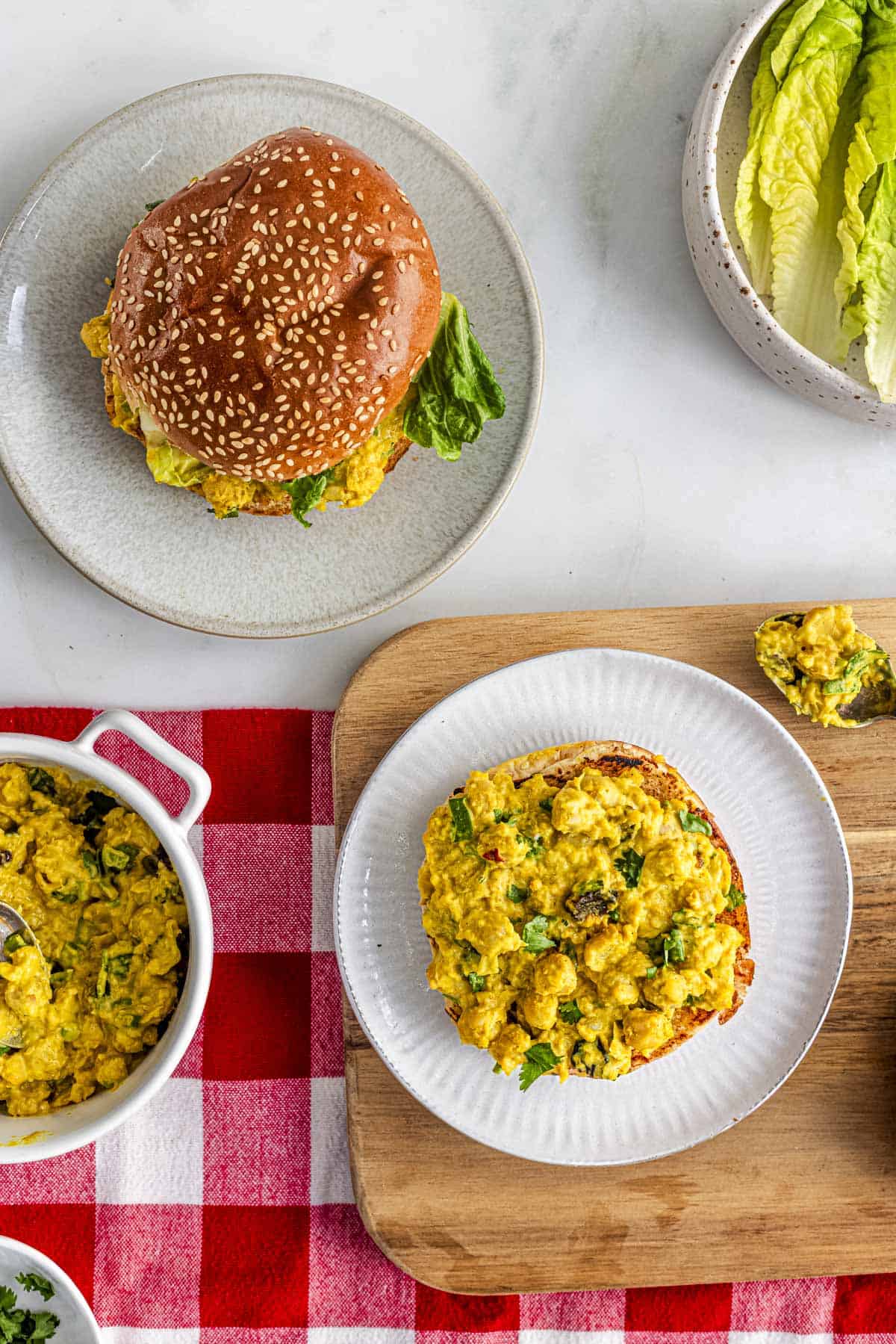 coronation chickpeas sandwich filling on top of burger bun.