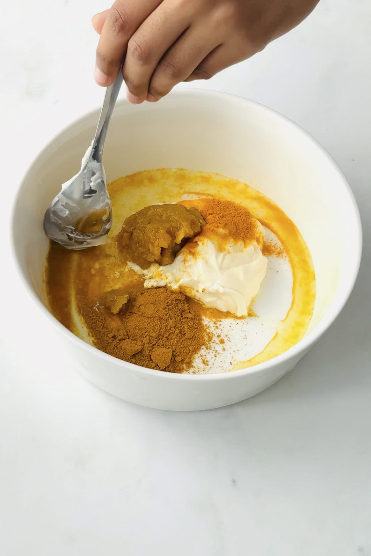mayo based sauce ingredients in a bowl to make coronation chickpeas.