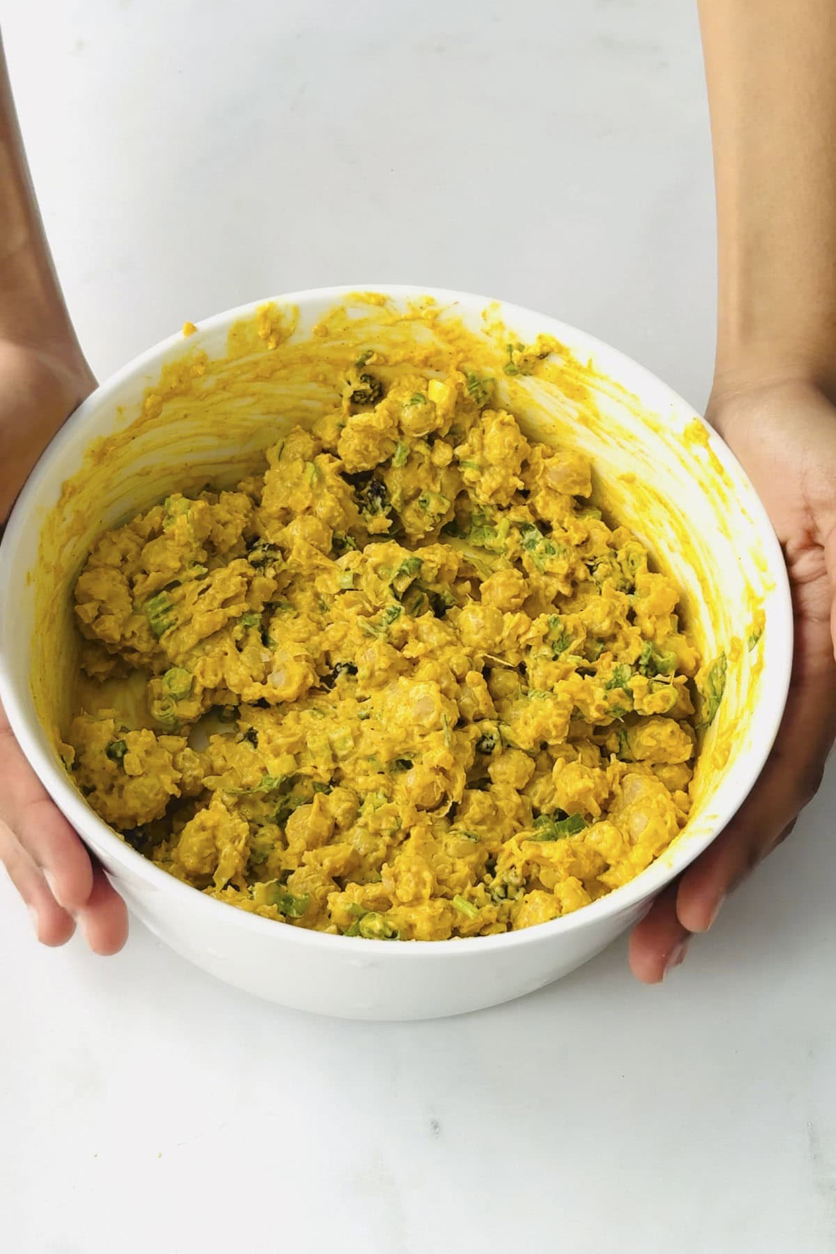 vegan coronation chickpeas in a white bowl.