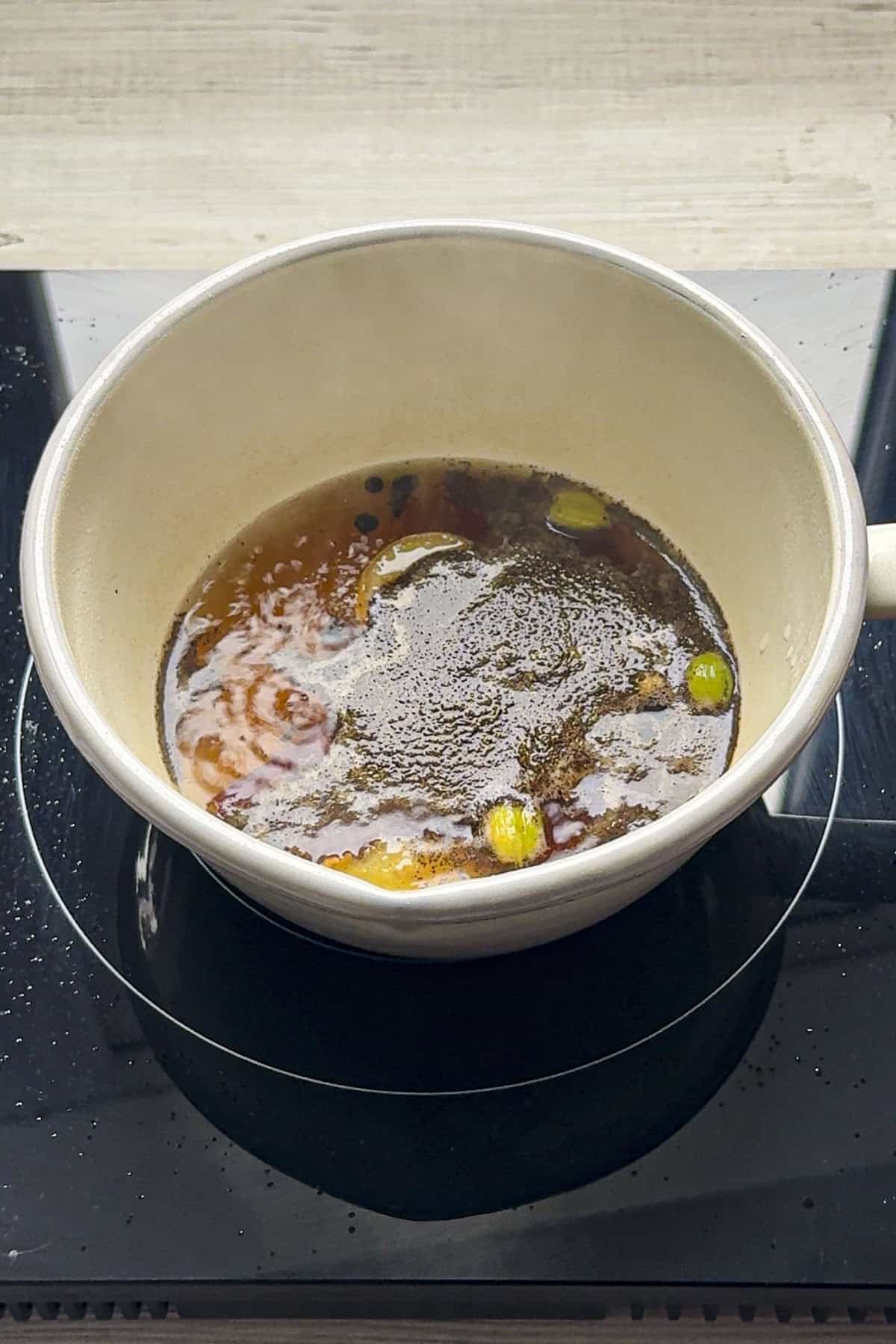 Simmering black tea with spices.