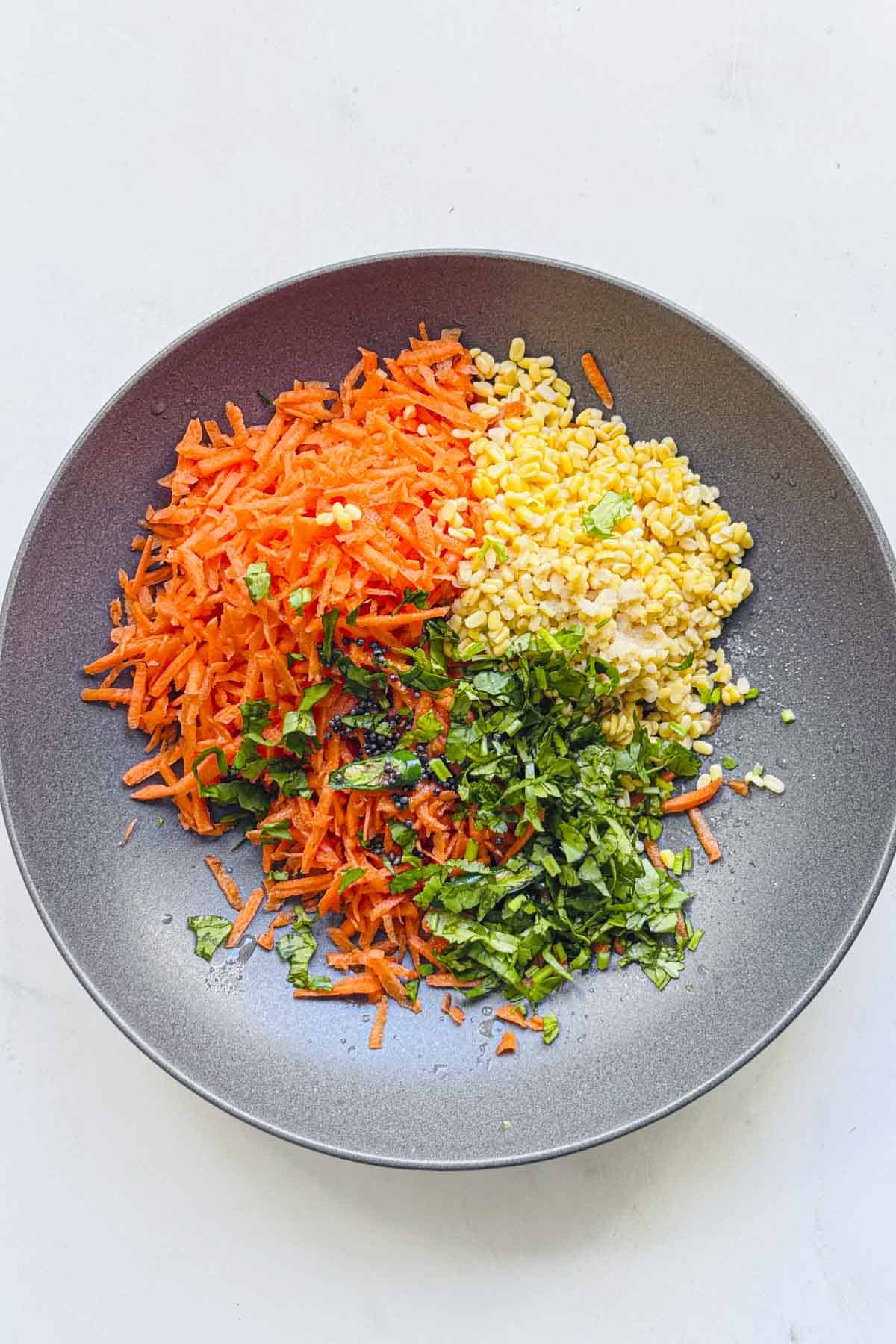 add all the ingredients to make Indian grated carrot salad to the wide bowl.