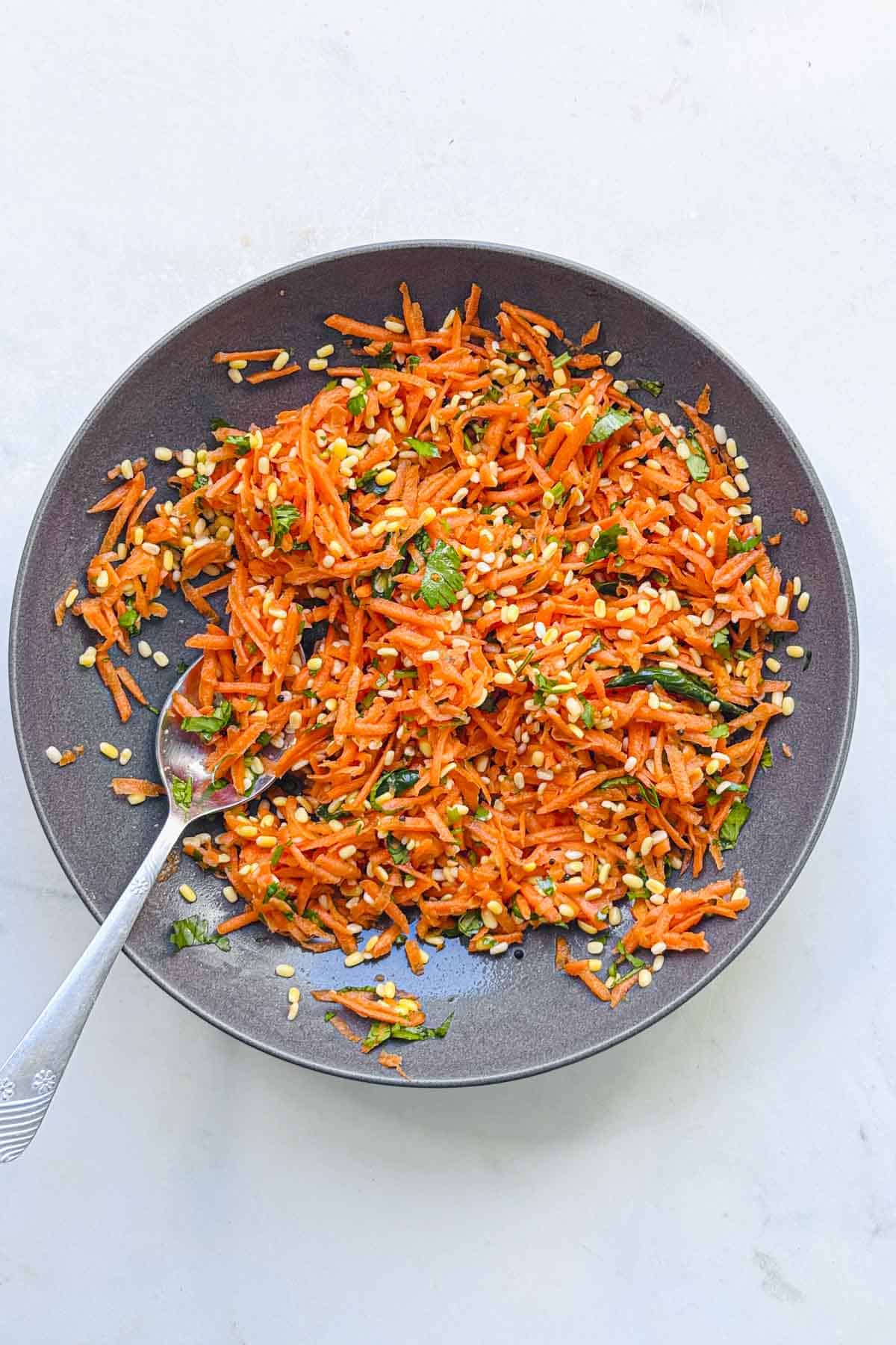 carrot moong dal kosambari salad in a bowl.