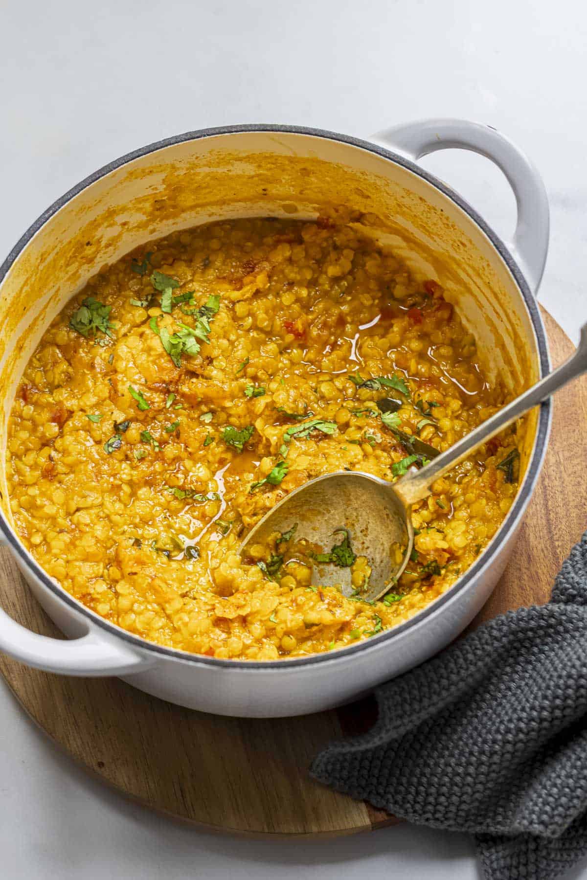 One Pot Vegan Indian red lentils dal in a white pot.