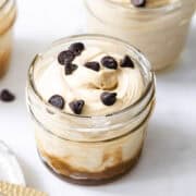 three jars of 3 ingredient easy caramel mousse topped with chocolate chips.