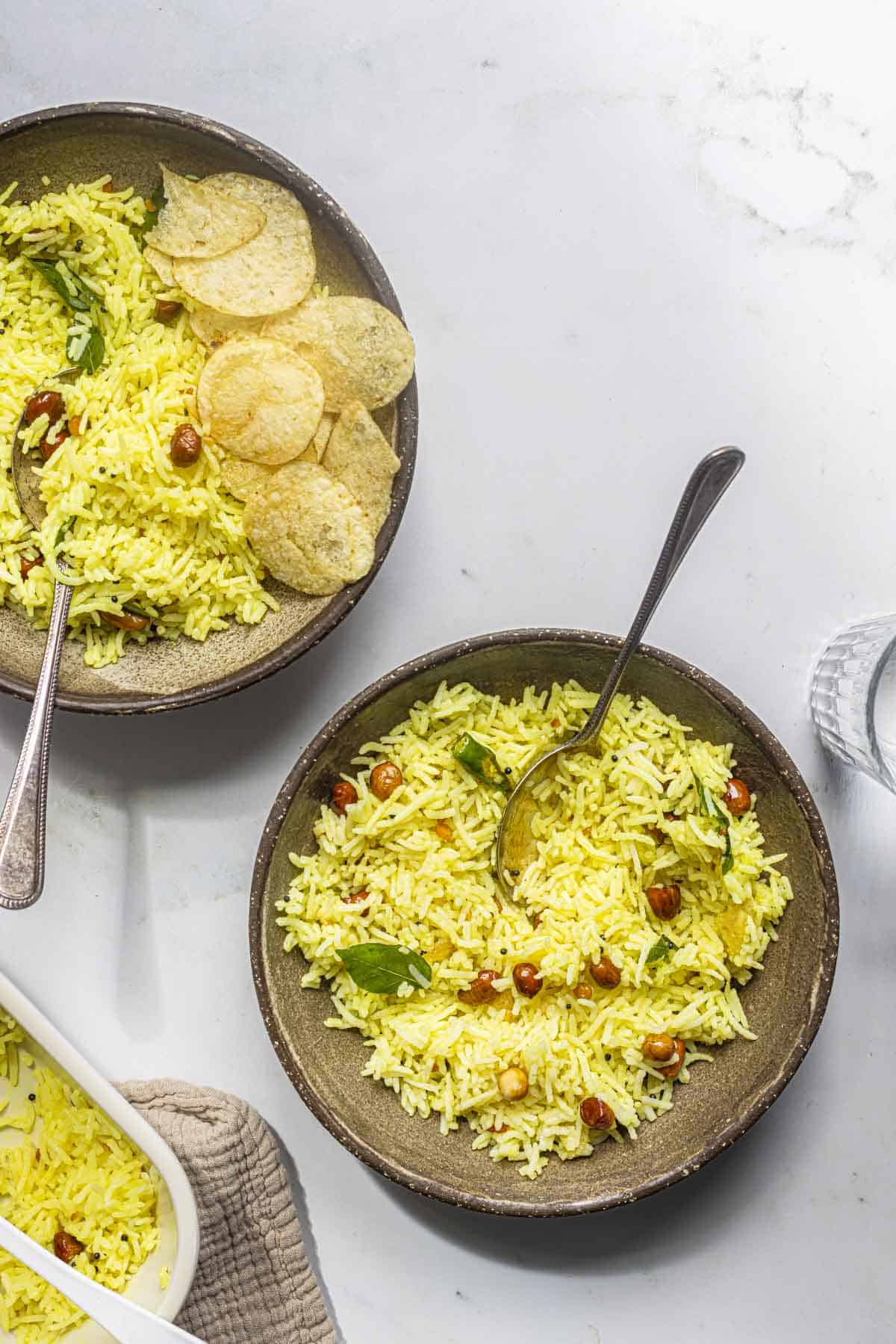 South Indian lemon rice served in brown bowls.