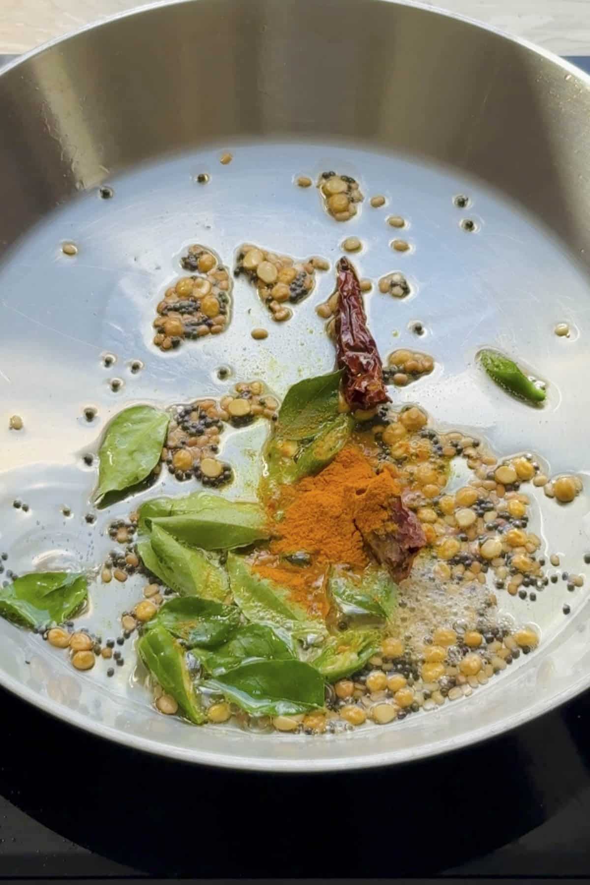 seasoning or tadka made in a frying pan for lemon rice.