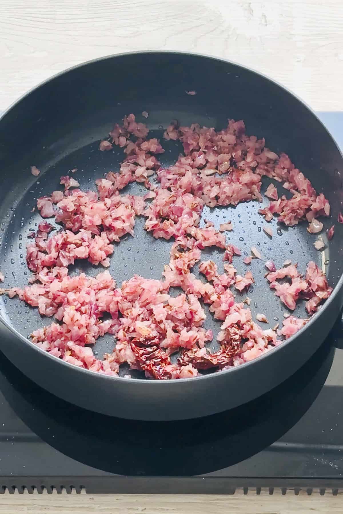 onion ginger garlic cooking in a saute pan.